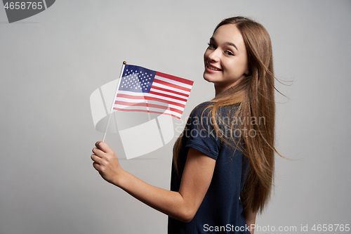 Image of Happy female holding USA flag