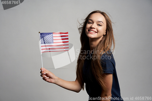 Image of Happy female holding USA flag