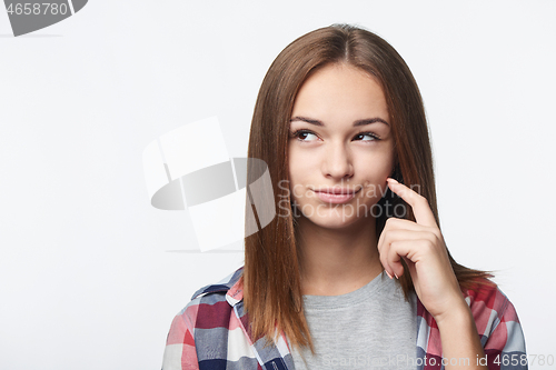 Image of Closeup portrait of thinking teen girl looking to side