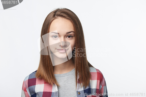 Image of Smiling relaxed teen girl looking at camera