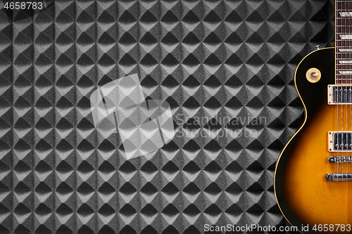 Image of Sunburst electric guitar on acoustic foam panel