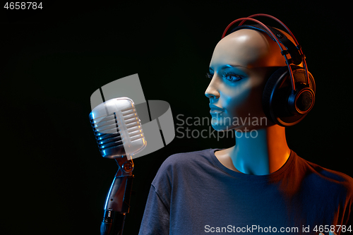 Image of Mannequin with studio retro condenser microphone and professional headphones