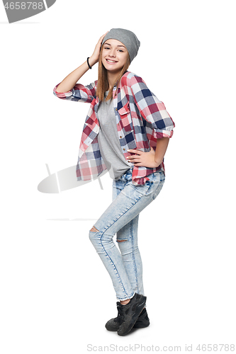 Image of Smiling relaxed teen girl standing in full length