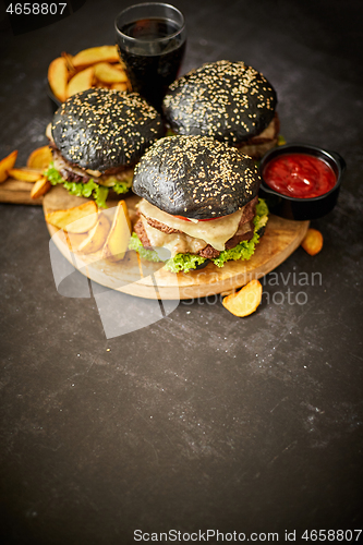 Image of Delicious black hamburger with patties and cheese