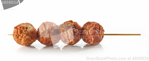 Image of baked meatballs on wooden skewer