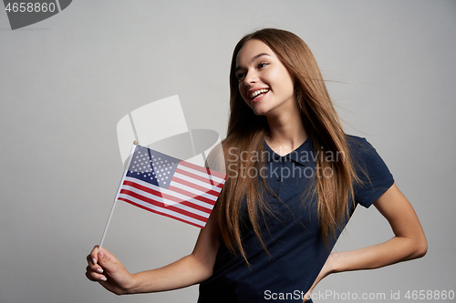 Image of Happy female holding United States flag