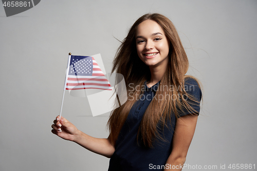 Image of Happy female holding America flag