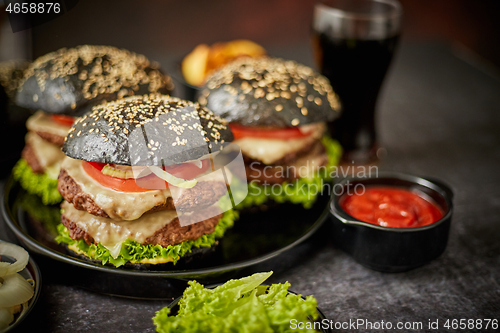 Image of Appetizing black hamburgers and fried potato