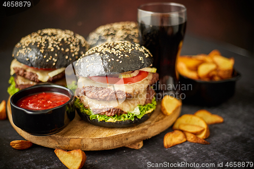 Image of Delicious black hamburger with patties and cheese