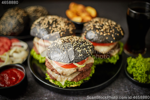 Image of Delicious black hamburger with patties and cheese