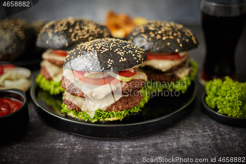 Image of Delicious black hamburger with patties and cheese