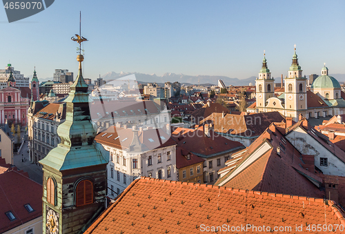 Image of Scenic panoramic aerial drone view of rooftops of medieval city center, town hall and cathedral church in Ljubljana, capital of Slovenia, at sunset