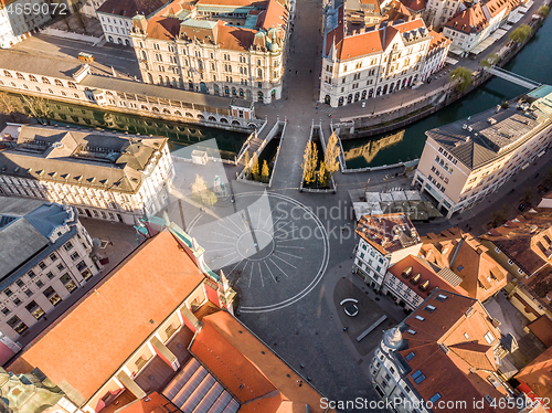 Image of Aerial drone view of Preseren Squere and Triple Bridge over Ljubljanica river,Tromostovje, Ljubljana, Slovenia. Empty streets during corona virus pandemic social distancing measures