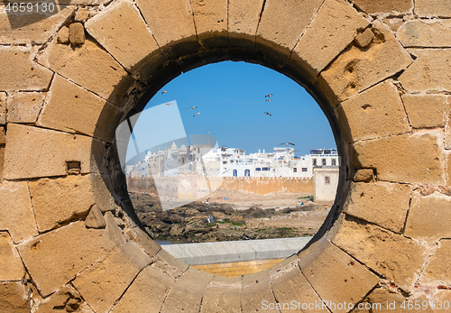 Image of View of Essaouira through hole in wall