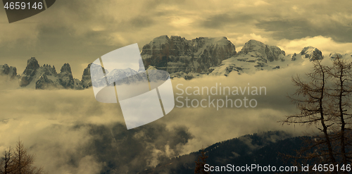 Image of Snow-capped alps mountains in clouds