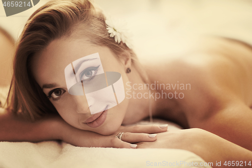 Image of woman getting back massage in spa salon