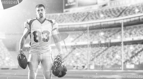 Image of American Football Player isolated on big modern stadium field