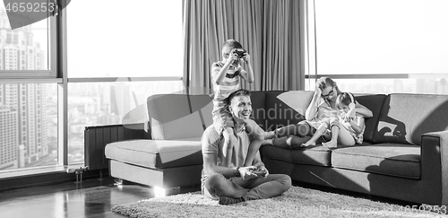 Image of Happy family playing a video game