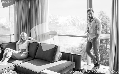 Image of couple relaxing at  home using tablet computer