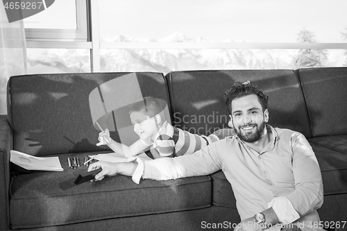 Image of Happy Young Family Playing Together on sofa