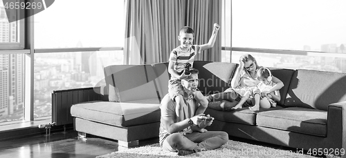 Image of Happy family playing a video game