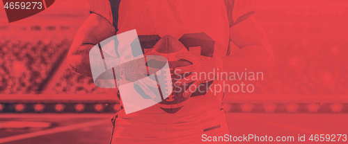 Image of closeup American Football Player isolated on big modern stadium