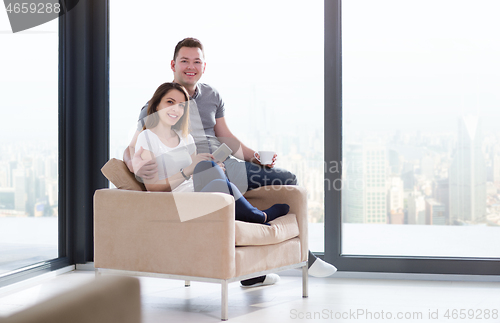 Image of couple using tablet at home