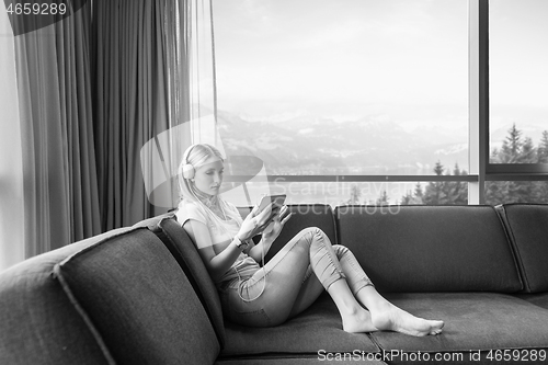 Image of young girl enjoying music through headphones