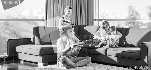 Image of Happy family playing a video game