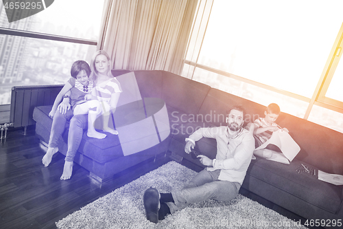 Image of Happy Young Family Playing Together on sofa