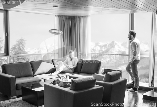 Image of couple relaxing at  home using tablet computer