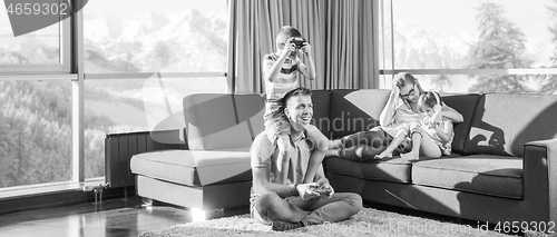 Image of Happy family playing a video game