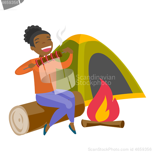 Image of Woman sitting on log near campfire in the camping.