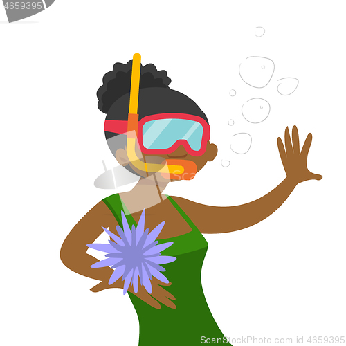 Image of Young african-american woman swimming underwater.