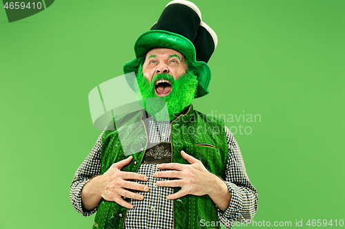 Image of A man in a leprechaun hat at studio. He celebrates St. Patrick\'s Day.