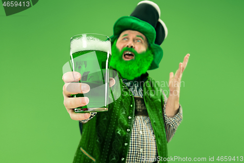 Image of A man in a leprechaun hat at studio. He celebrates St. Patrick\'s Day.