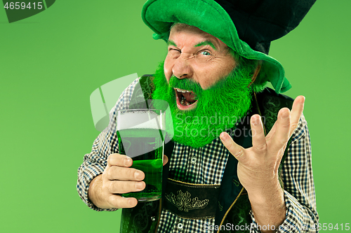 Image of A man in a leprechaun hat at studio. He celebrates St. Patrick\'s Day.