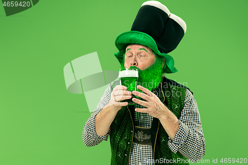 Image of A man in a leprechaun hat at studio. He celebrates St. Patrick\'s Day.