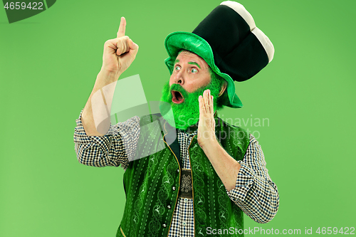 Image of A man in a leprechaun hat at studio. He celebrates St. Patrick\'s Day.