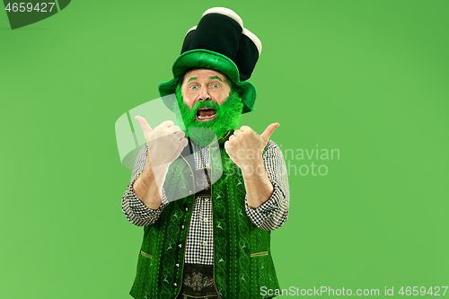 Image of A man in a leprechaun hat at studio. He celebrates St. Patrick\'s Day.