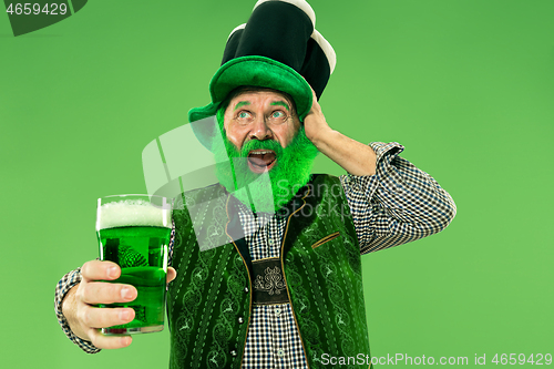 Image of A man in a leprechaun hat at studio. He celebrates St. Patrick\'s Day.