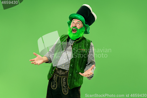 Image of A man in a leprechaun hat at studio. He celebrates St. Patrick\'s Day.