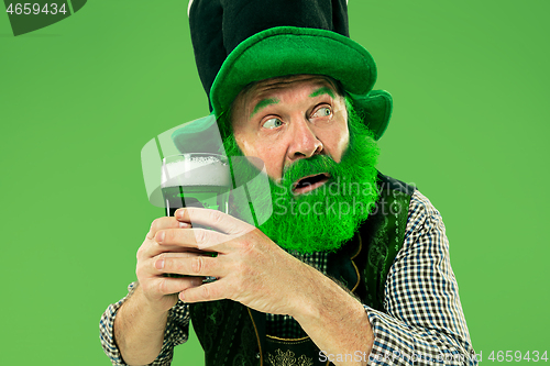 Image of A man in a leprechaun hat at studio. He celebrates St. Patrick\'s Day.