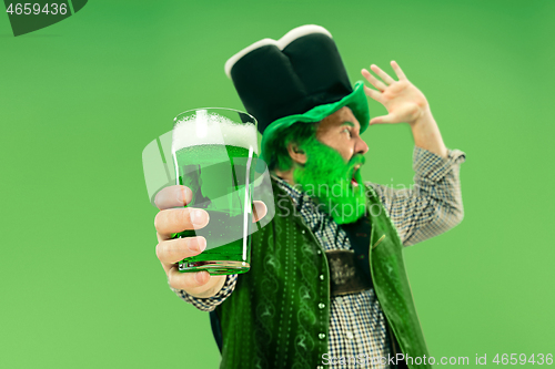 Image of A man in a leprechaun hat at studio. He celebrates St. Patrick\'s Day.