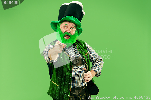 Image of A man in a leprechaun hat at studio. He celebrates St. Patrick\'s Day.