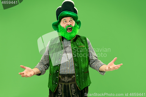 Image of A man in a leprechaun hat at studio. He celebrates St. Patrick\'s Day.