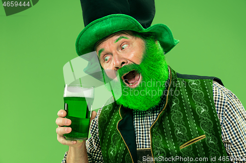 Image of A man in a leprechaun hat at studio. He celebrates St. Patrick\'s Day.