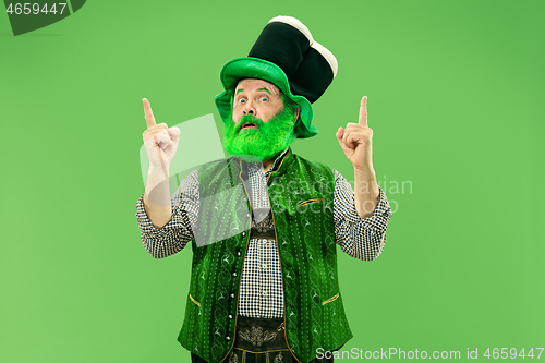 Image of A man in a leprechaun hat at studio. He celebrates St. Patrick\'s Day.