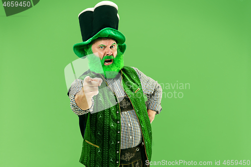 Image of A man in a leprechaun hat at studio. He celebrates St. Patrick\'s Day.