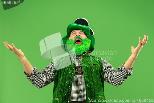 Image of A man in a leprechaun hat at studio. He celebrates St. Patrick\'s Day.